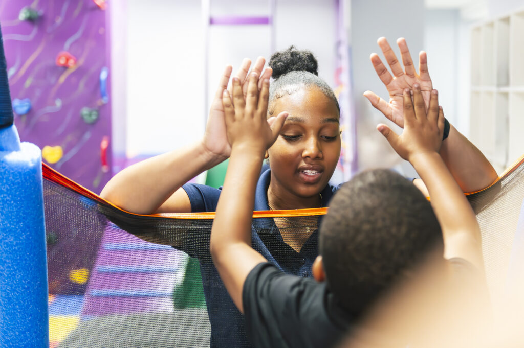 ABA therapist working with kid in an ABA session