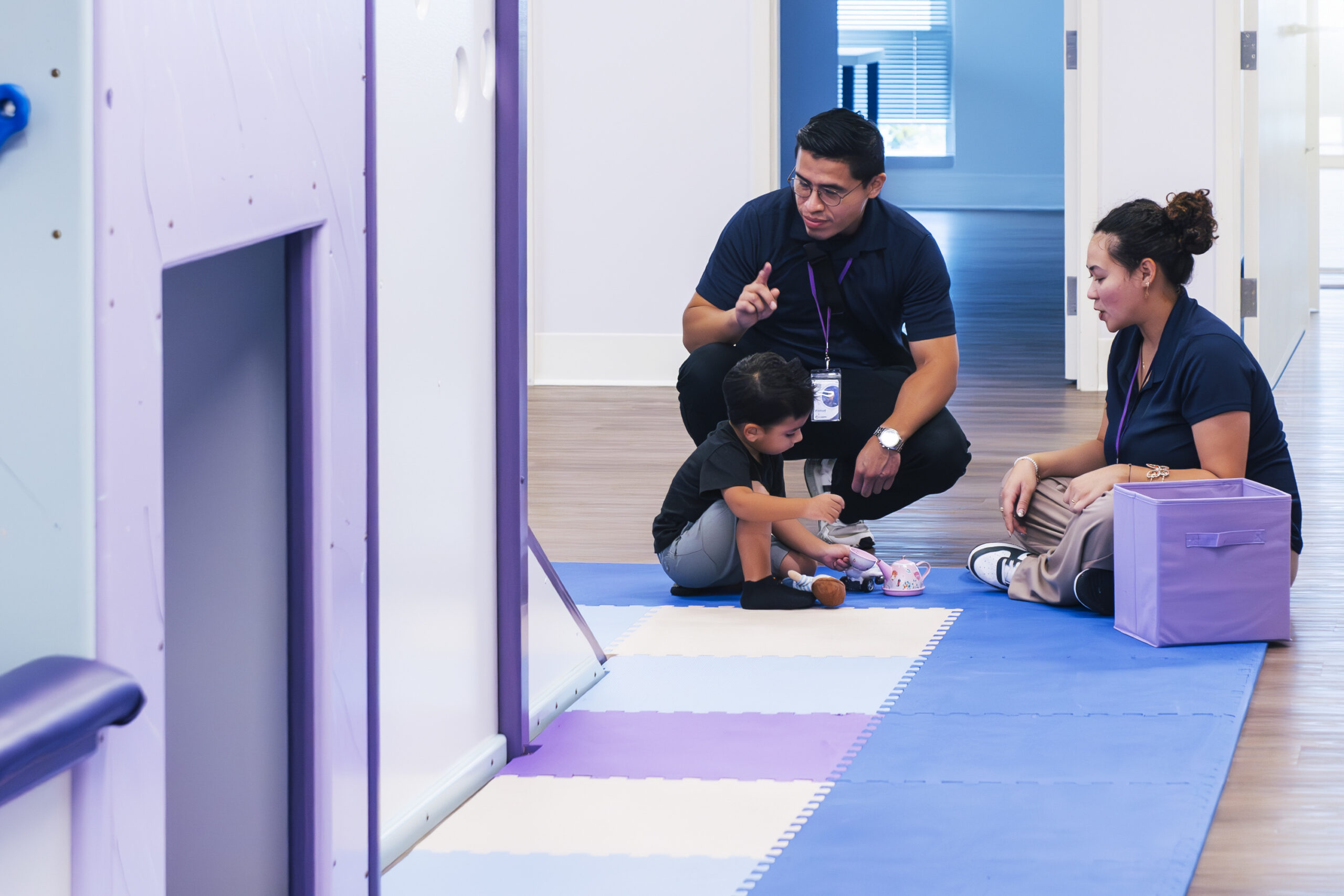 ABA therapists working in an ABA sessiones teaching coping mechanisms to kid on the spectrum