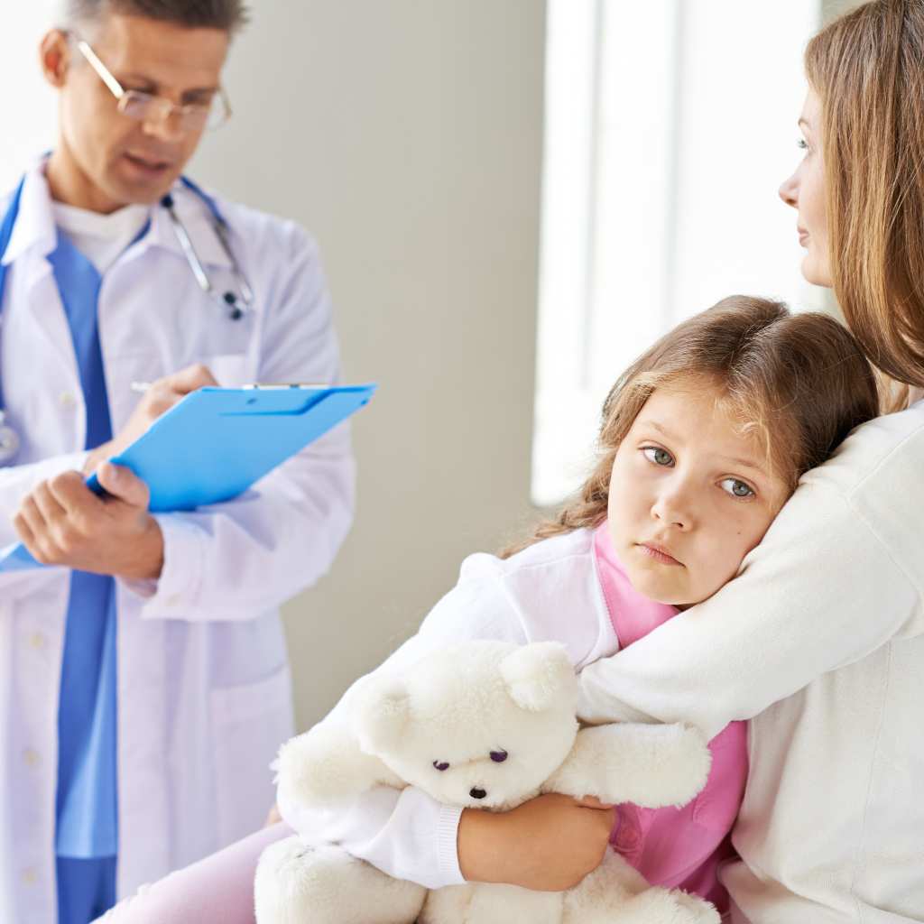 A doctor speaking with a parent and child about a possible PDA diagnosis