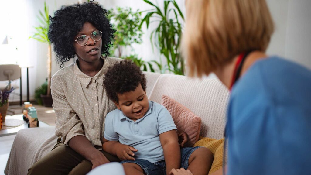 A parent and young child meeting with a clinician to explain difference between adhd and autism