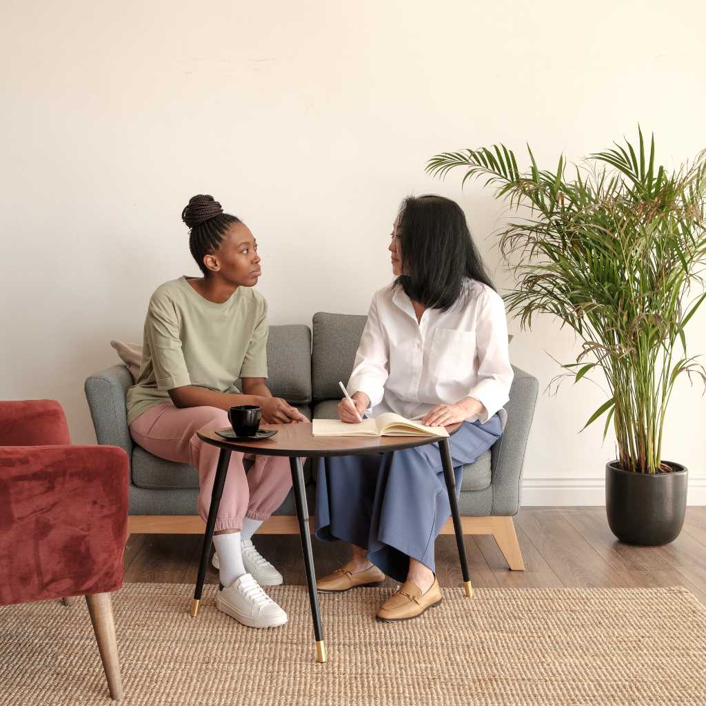 Therapist and client sitting together and talking, representing the supportive role of ABA therapy in autism self-advocacy