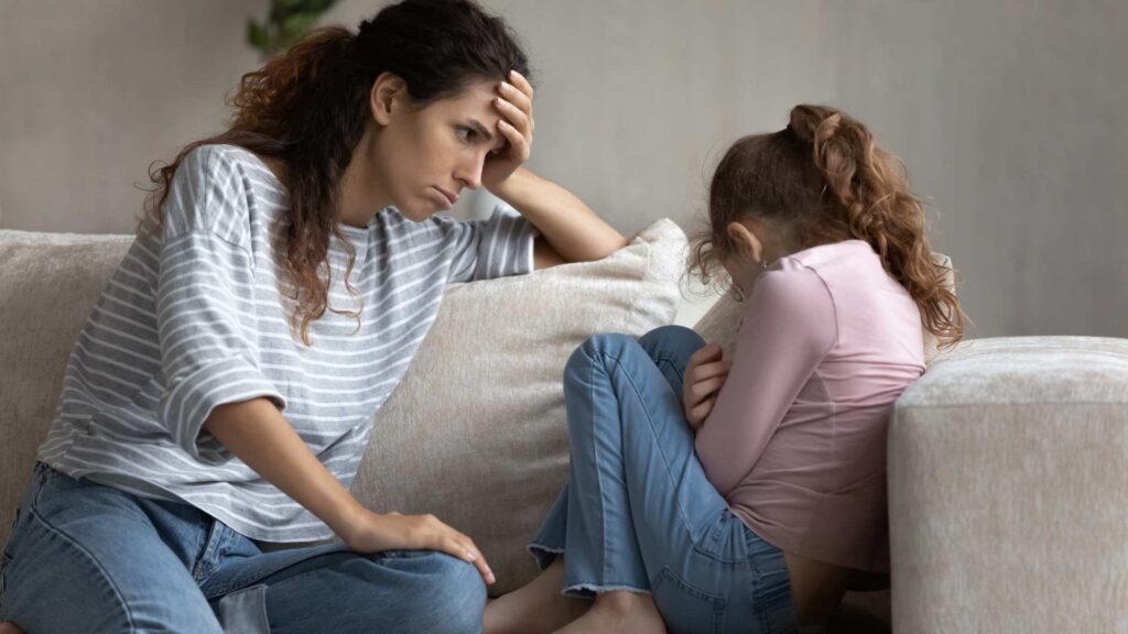 An adult comforting a child while discussing the challenges of PDA in autism