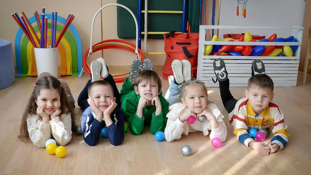 Group of toddlers in playroom, social interaction and applied behavior analysis for toddlers