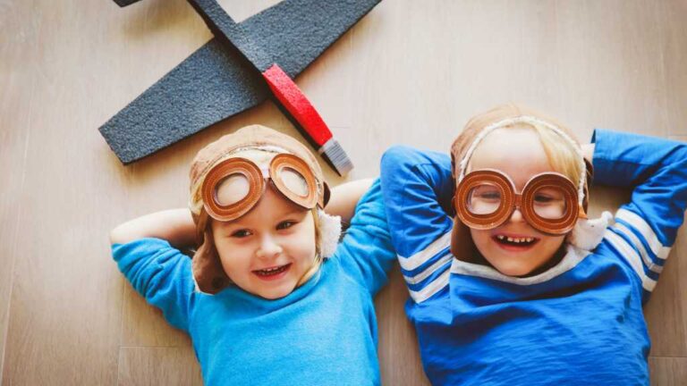 Children playing with airplane goggles, representing the connection between autism and mental health.