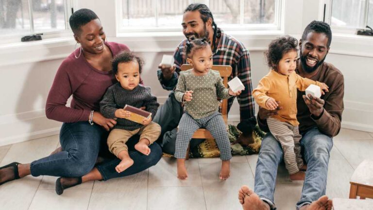 Parents engaging toddlers in play to observe early signs of autism at 12 months
