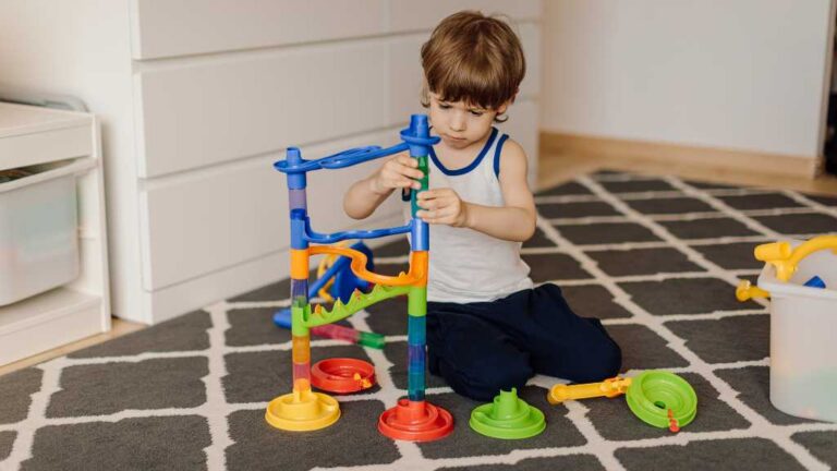 2-year-old assembling toy structure, focused play and signs of autism in a 2-year-old