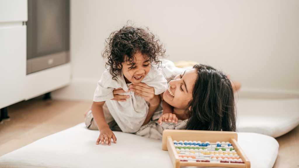 Parent playing with toddler, encouraging response to name in young child