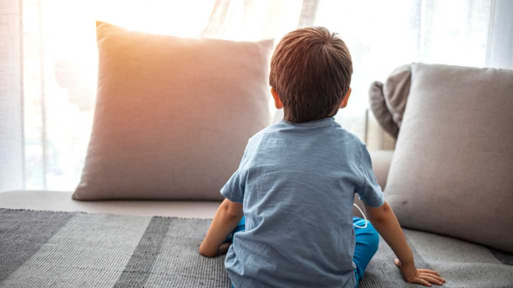 Toddler sitting with back turned, toddler not responding to name