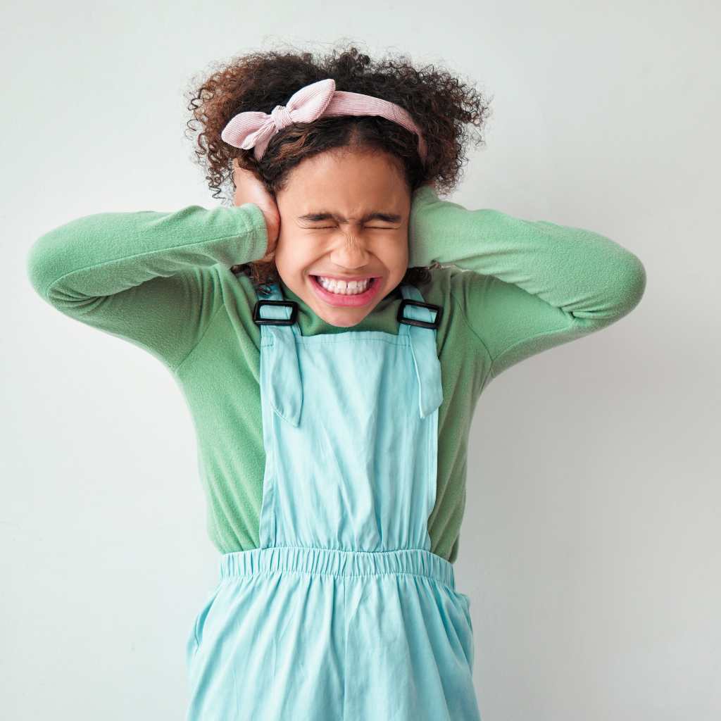 Child covering ears from sensory overload – understanding why public spaces trigger overwhelm in autism.