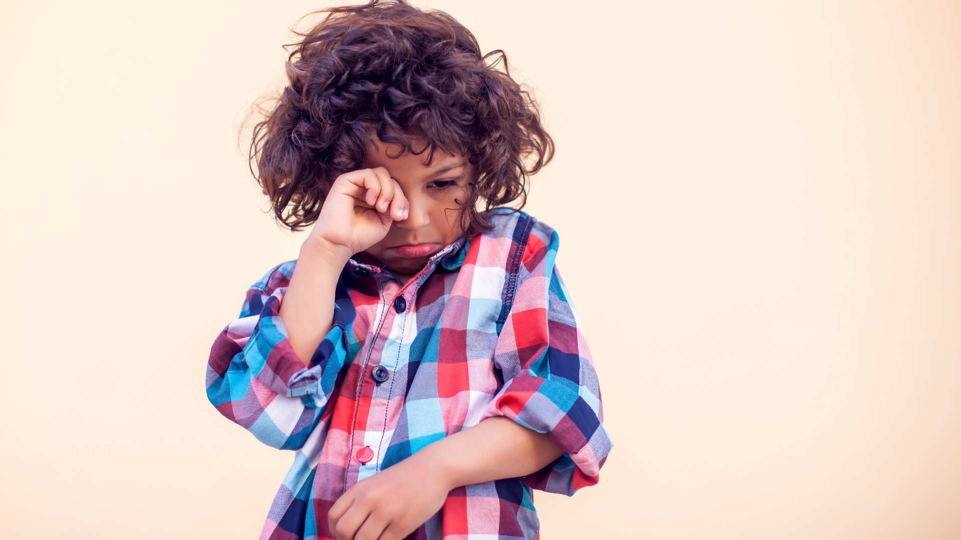 Young child rubbing their eye, shown as an illustration for autistic rumination