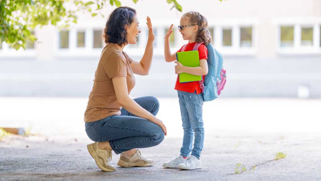 Caregiver giving child a high five during ABA parent training