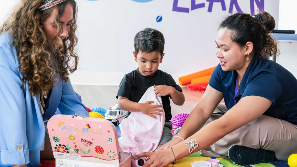 ABA therapist qualifications supporting a child during play-based therapy