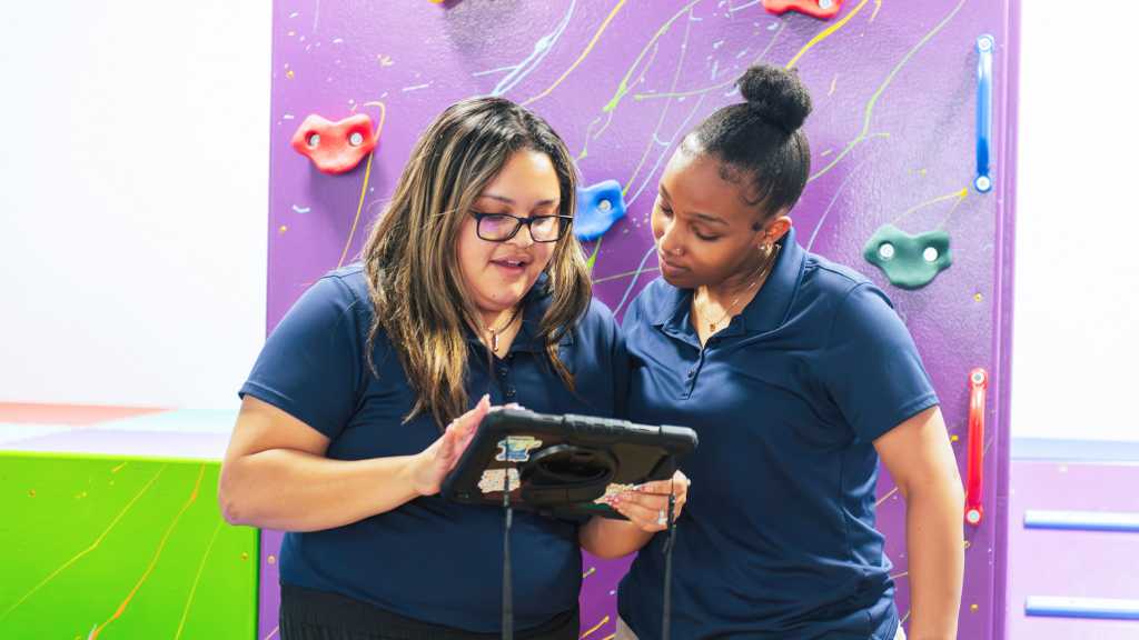 ABA therapy team reviewing clinical notes on a tablet
