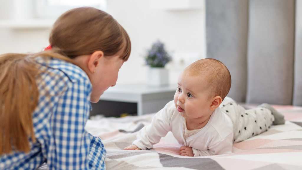 Parent engaging face-to-face with baby, autism and eye contact development in early communication