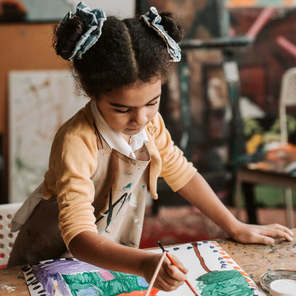 Child painting during school activity with autism support