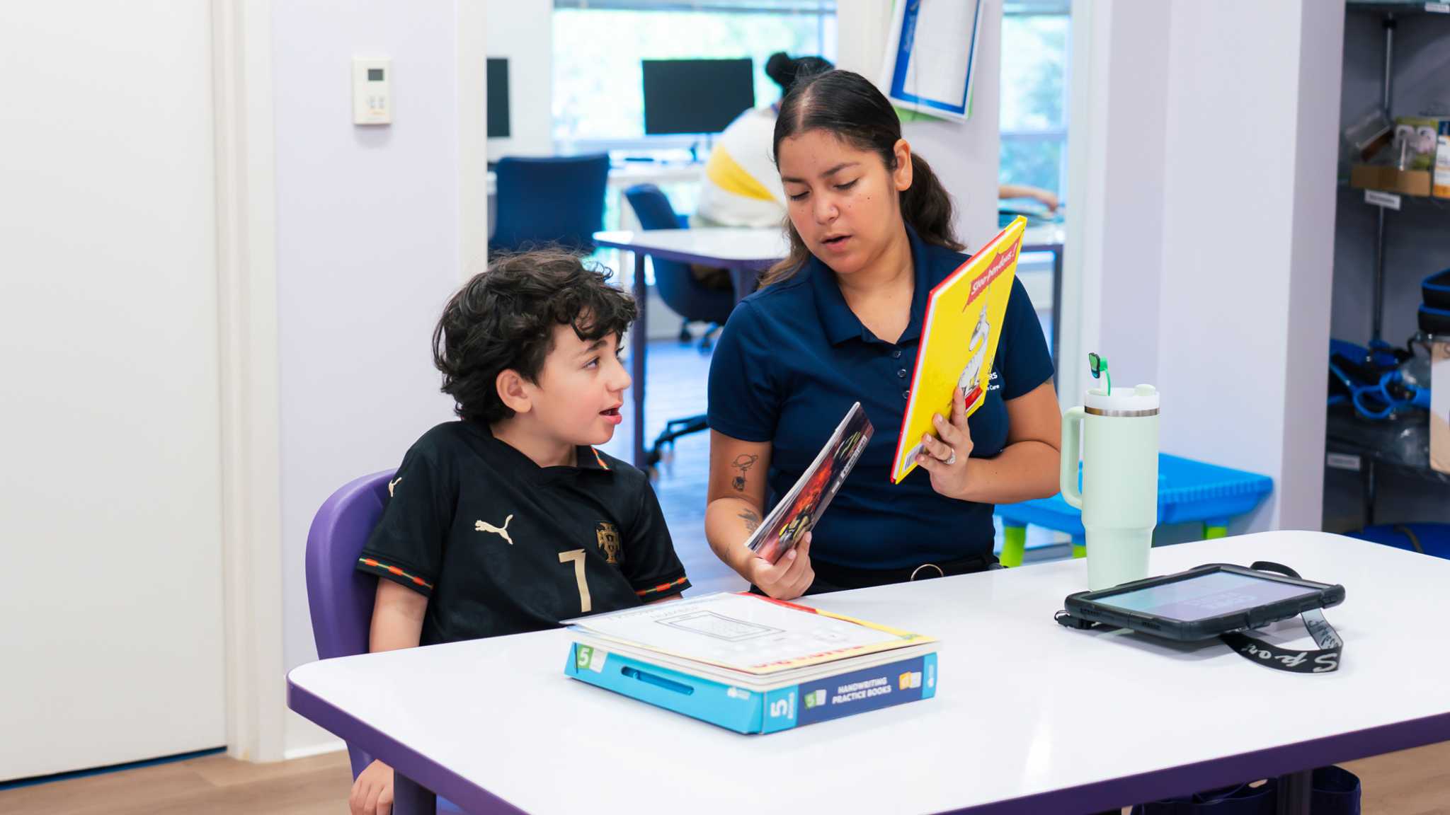 Therapist reviewing materials with a child after an autism assessment report