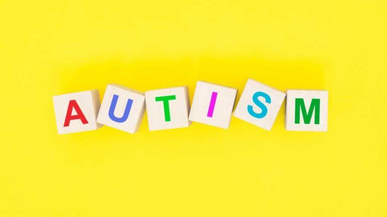 Explaining autism letter blocks on yellow background