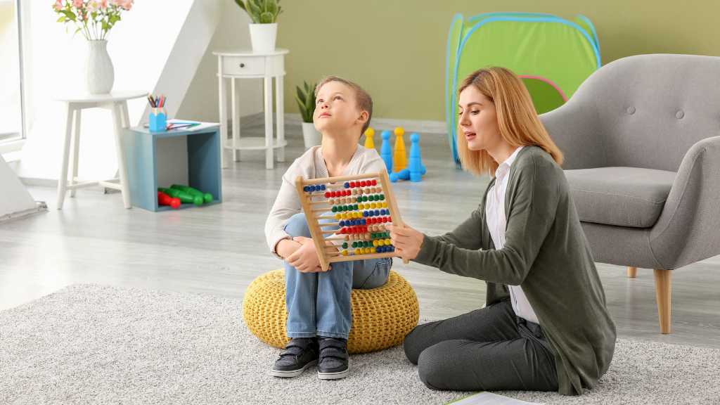 Therapist working with child, autism diagnosis and developmental screening activities