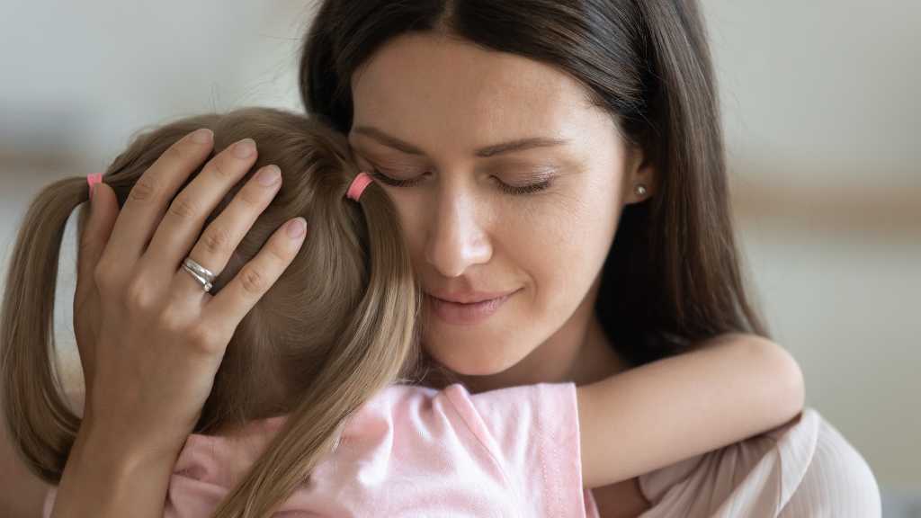 Mother comforting child after autism diagnosis, emotional support for families
