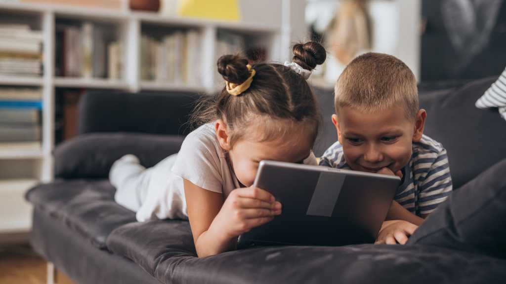 Children showing focused attention while using a tablet, an example of special interests in autism