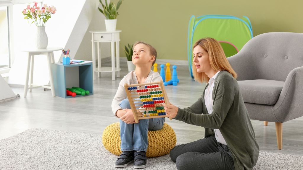 Adult supporting a child during a learning activity with an abacus