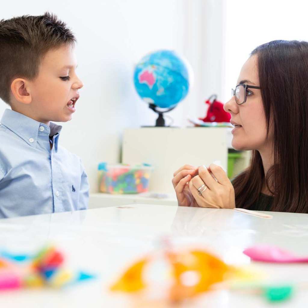 Therapist supporting a young child’s communication during autism therapy for toddlers