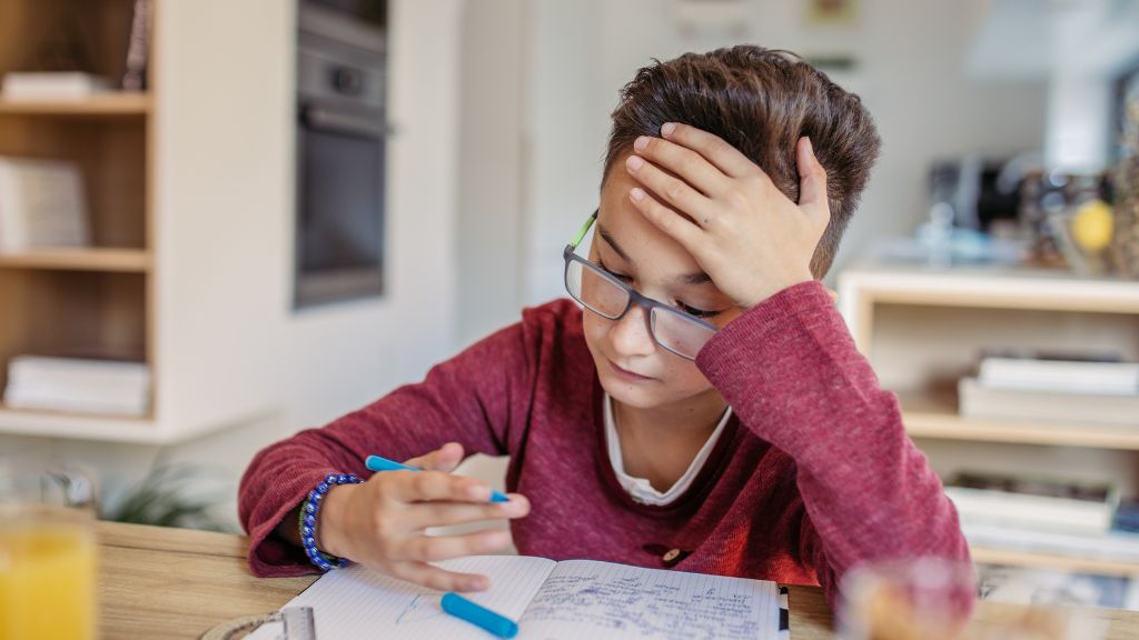 Child feeling overwhelmed while completing schoolwork at home