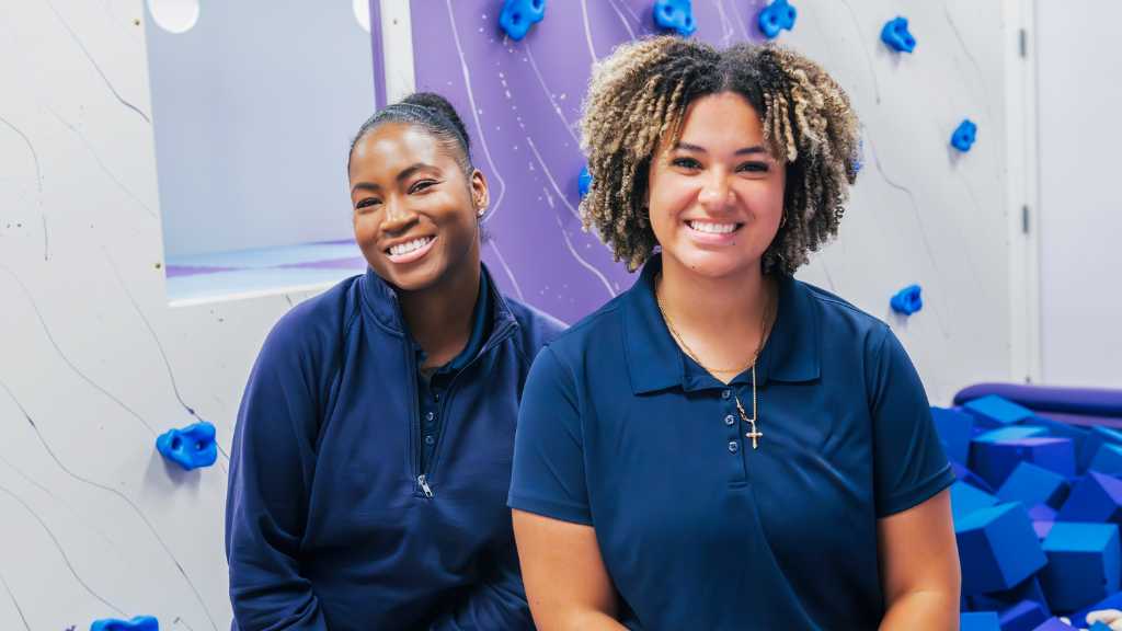 Autism behavior specialists smiling in a pediatric therapy center