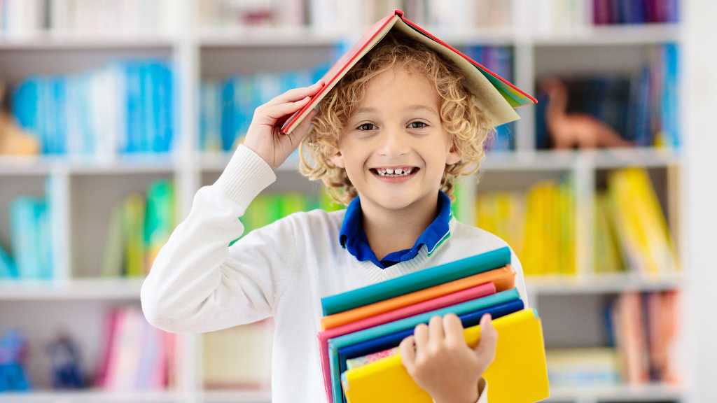 autism and school Child smiling with books in school library