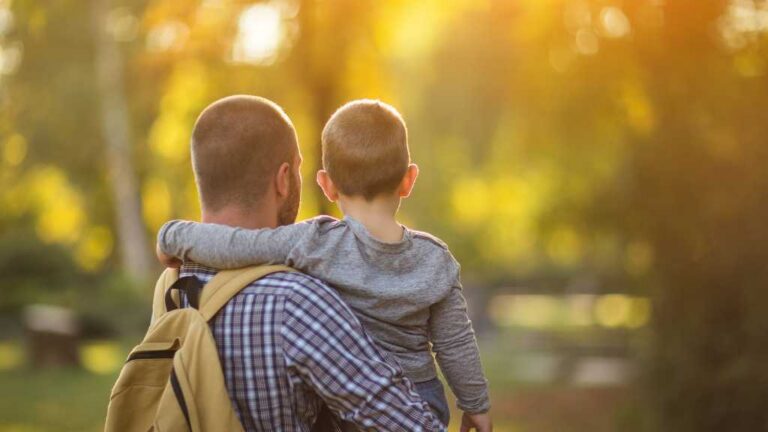Parent carrying child after being diagnosed with autism, family support and care