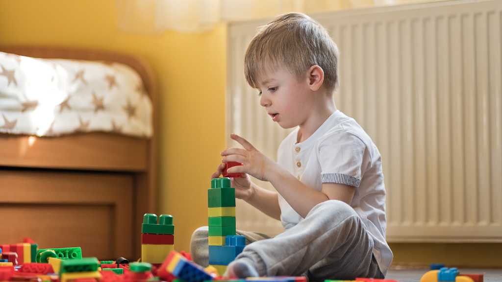 Child stacking blocks, child not responding to name while focused on activity
