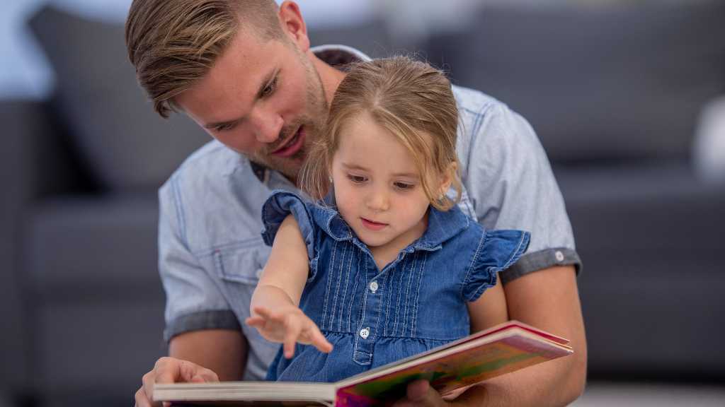 Parent reading with child after autism diagnosis
