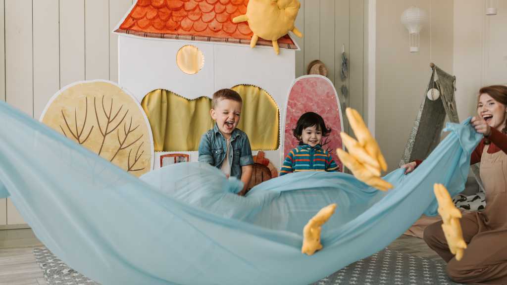 Children participating in early autism therapy through a playful group activity with a therapist