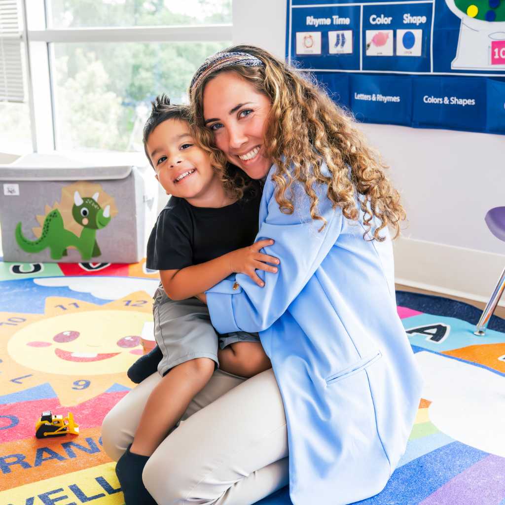Therapist smiling with a young child during early intervention ABA therapy