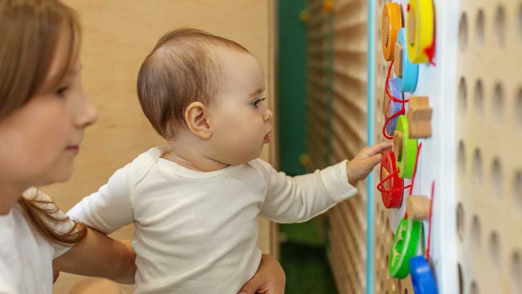 Young child exploring a sensory learning activity during early intervention therapy