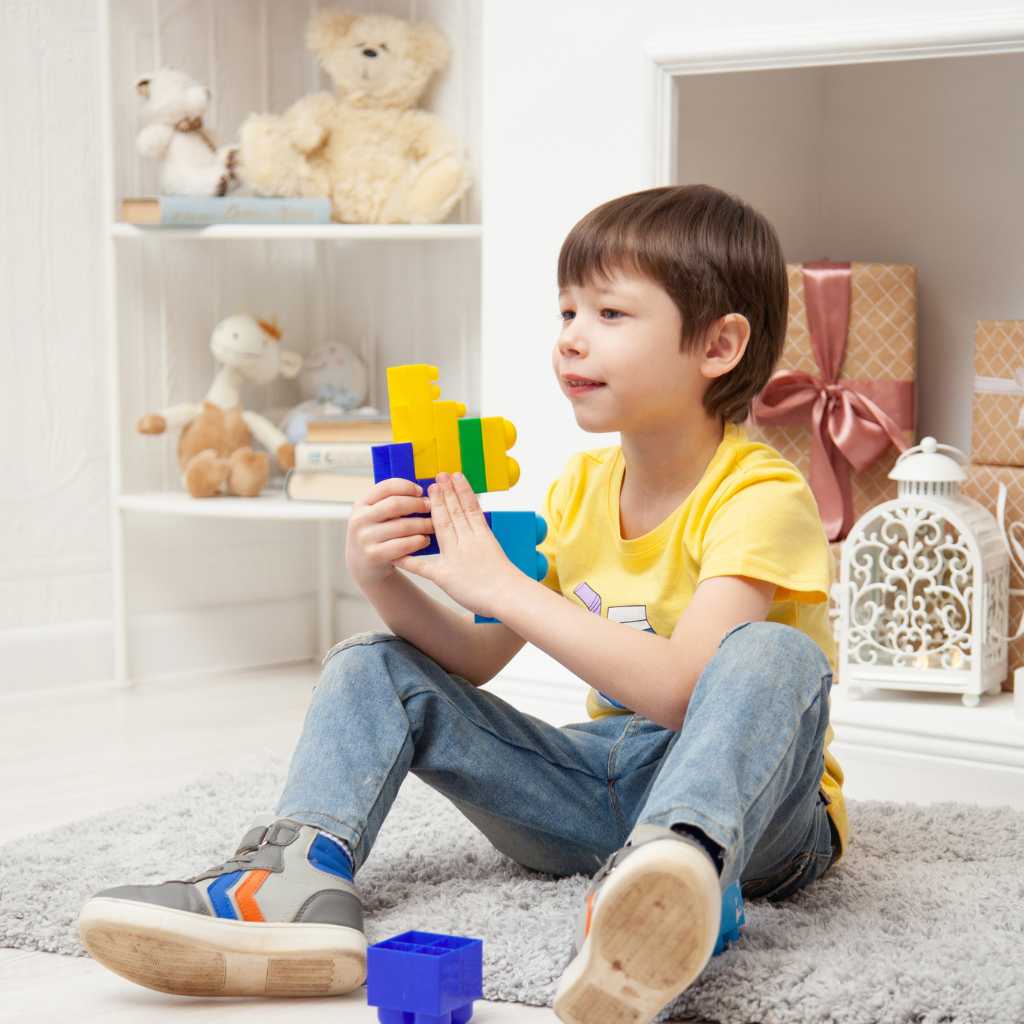 Child playing with blocks while learning through autism support