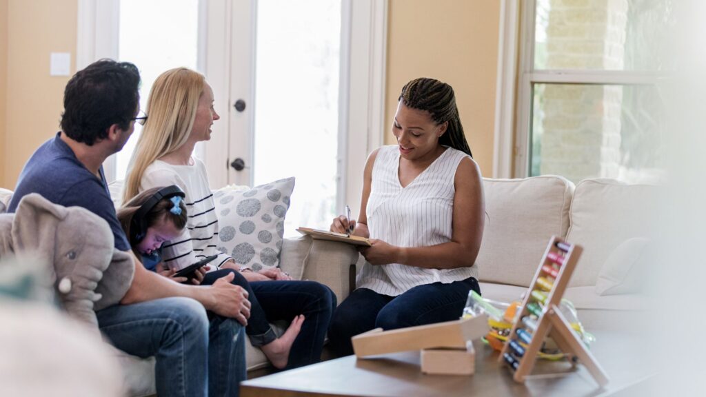 Family meeting with a professional to discuss the members of their child's autism support team