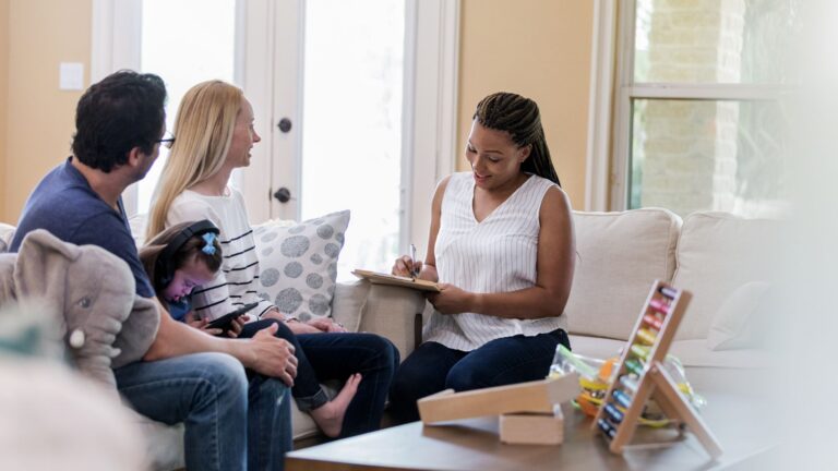Family meeting with a professional to discuss the members of their child's autism support team