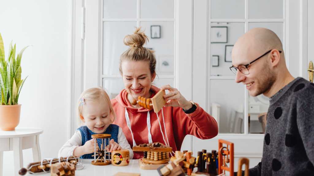 Family playing together after autism diagnosis, home support and developmental activities