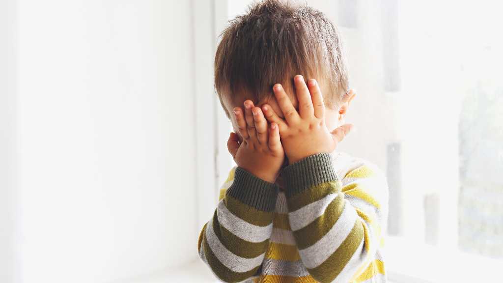 Toddler covering face, meltdowns in autism and sensory overload