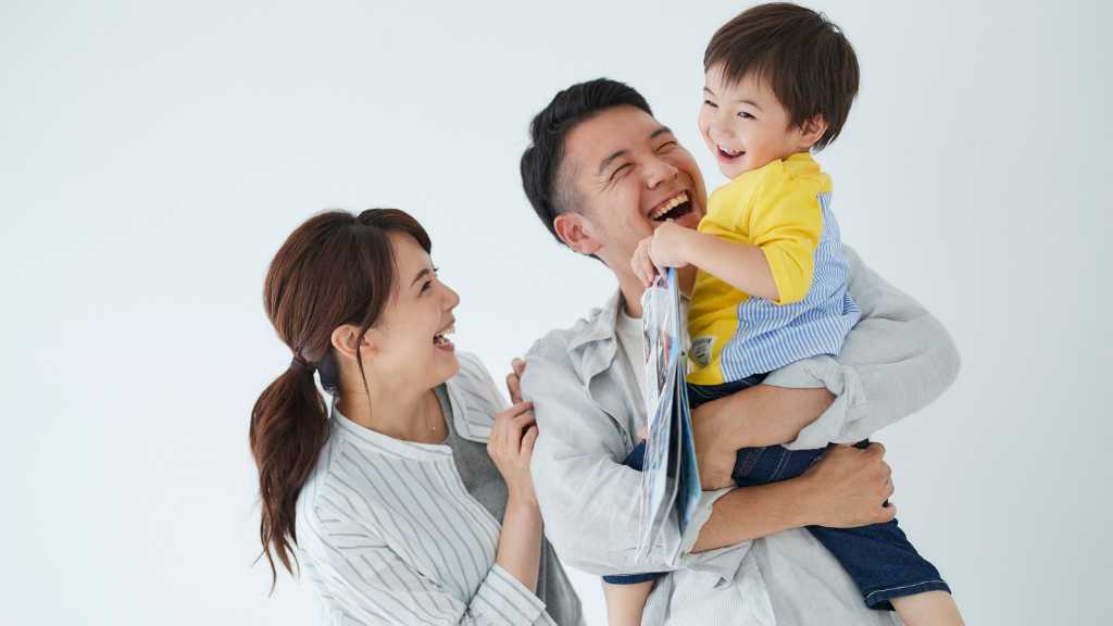 Parents smiling with child after autism diagnosis