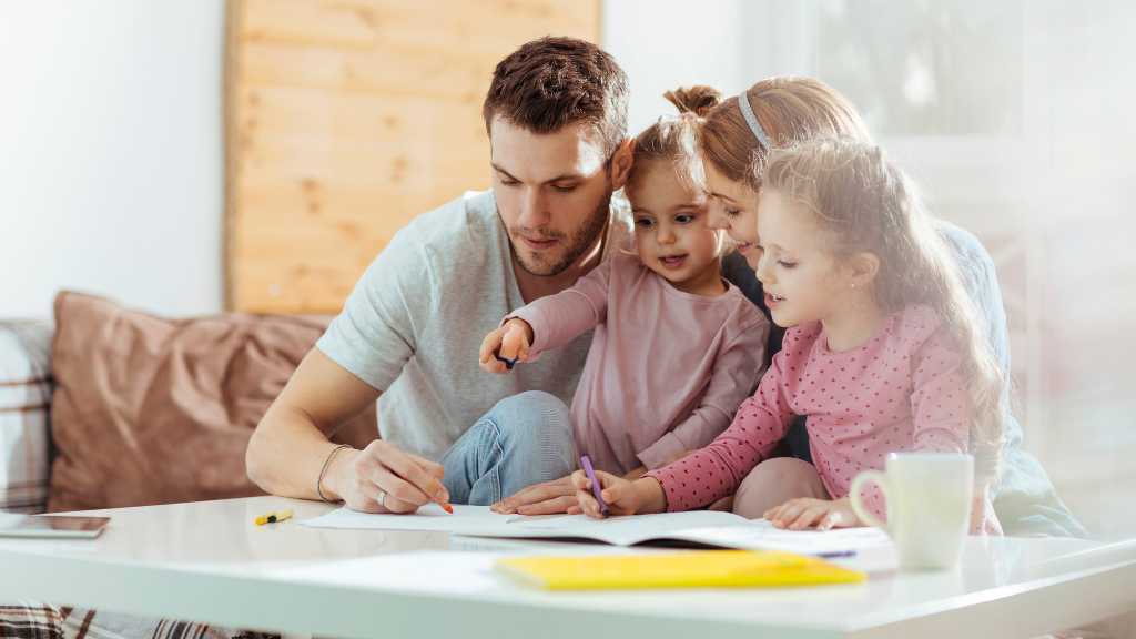 Parents supporting children during ABA therapy activities at home