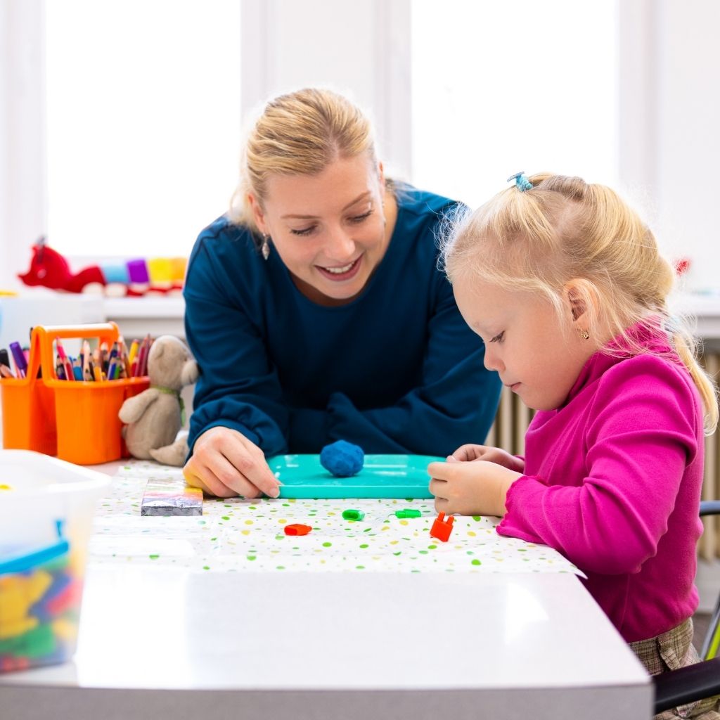 Child participating in a play-based activity with a therapist in an ABA therapy for preschoolers session