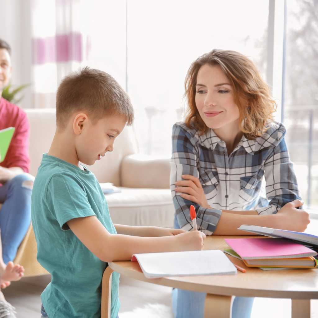 Parent and child practicing learning skills with ABA caregiver support