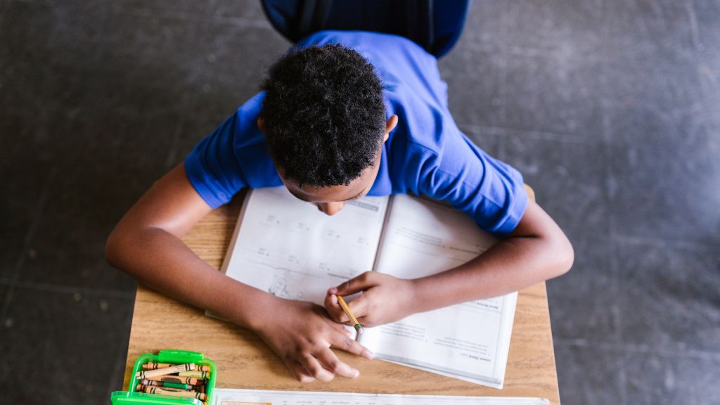 Child completing schoolwork as part of back-to-school preparation