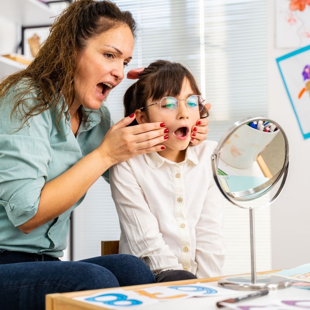 Child practicing communication skills with in speech therapy, one of the types of therapy for autism