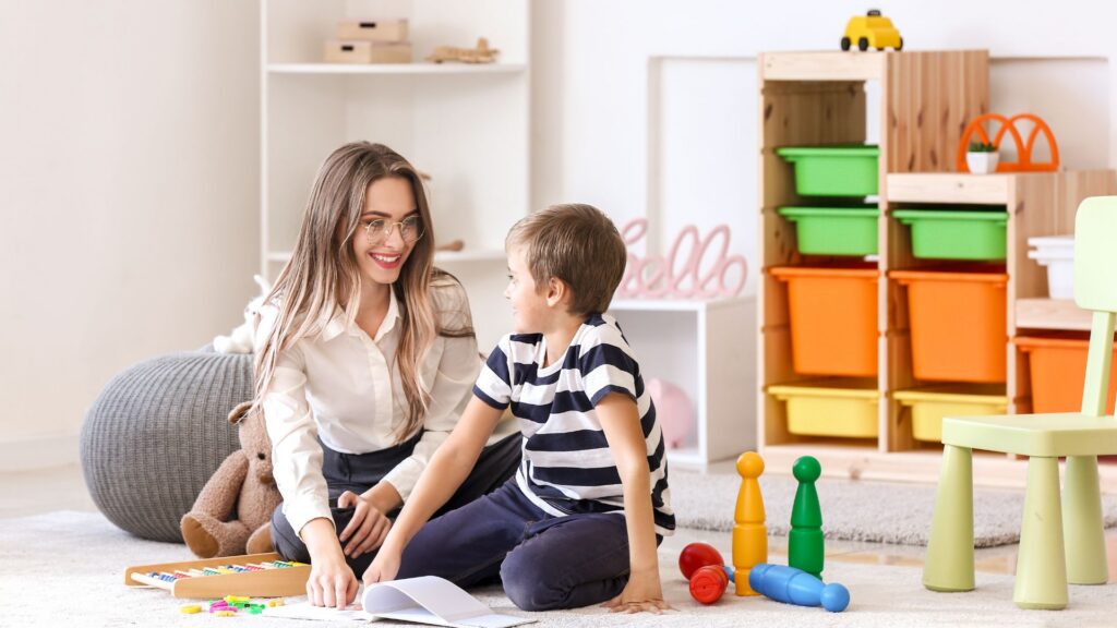 Child working with a professional in a play-based learning environment, with ABA as one of the types of therapy for autism