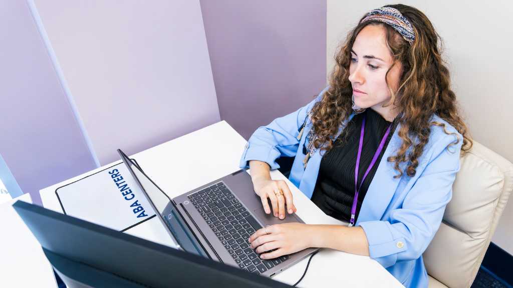 What is a BCBA? Board Certified Behavior Analyst reviewing a toddler care plan on a laptop